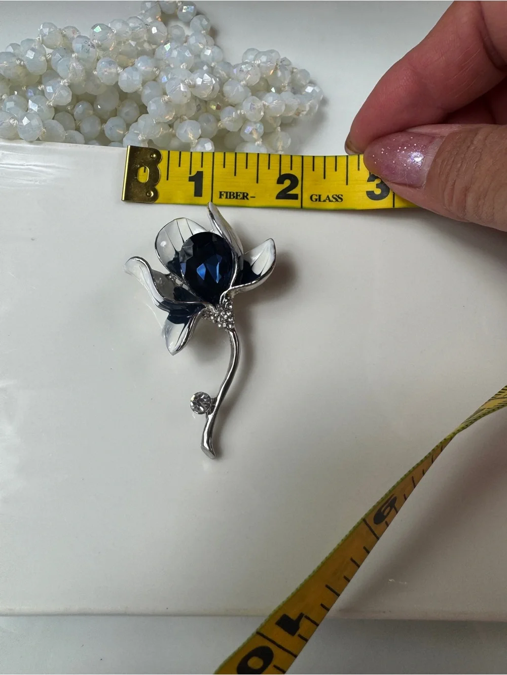 Silver Floral Brooch with Deep Blue Faceted Crystal